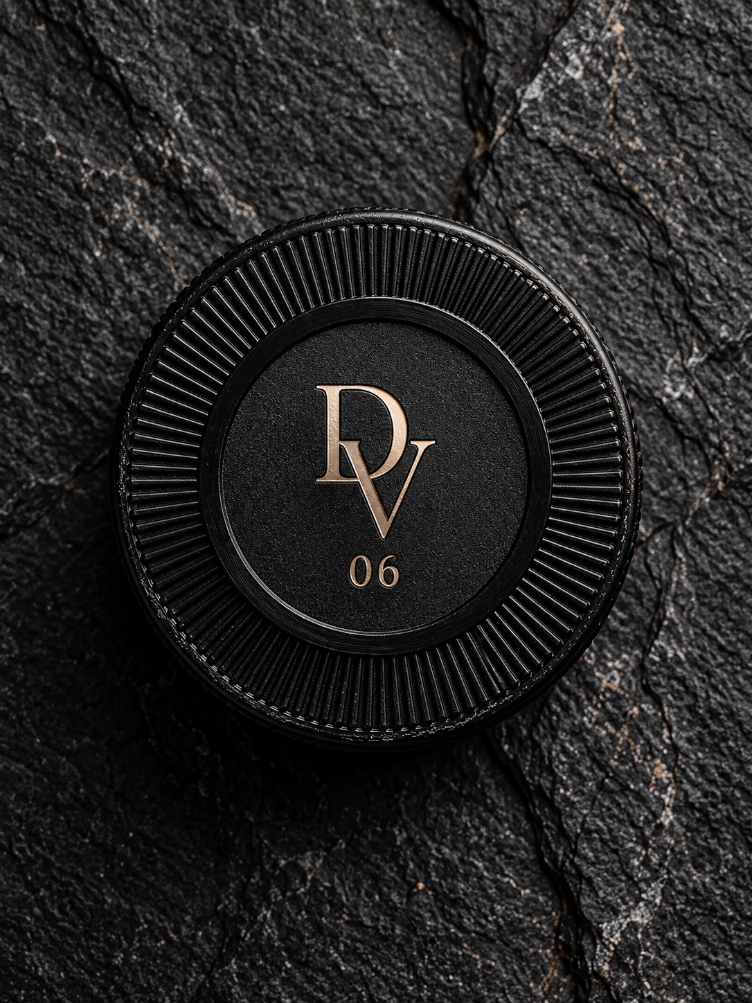 DRAVOSS DV 06 seal on a matte black cap, set against stone